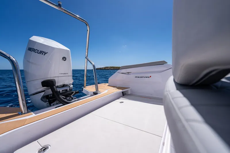 Slide: The Image of 2025 Axopar Sun-Top boat dashboard with steering wheel, dual screens, and control panel. - 28