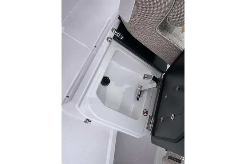 Slide: The Image of 2025 Axopar Sun-Top boat sink with closed lid and faucet. - 32