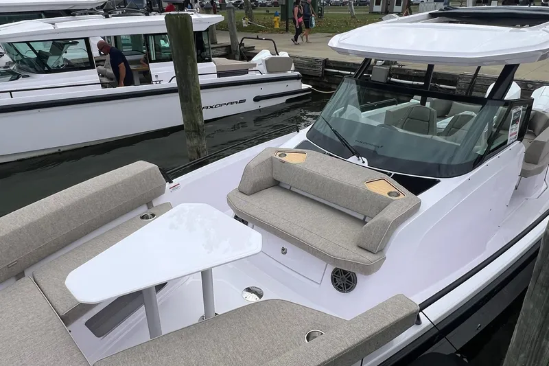 Slide: The Image of 2025 Axopar Sun-Top boat with sleek design, spacious seating, and modern amenities docked at marina. - 39