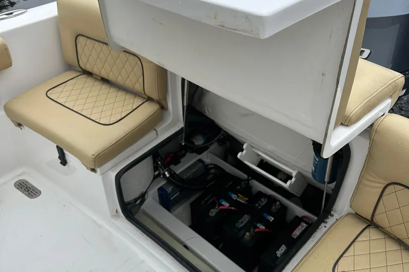 Slide: The Image of 2021 Sportsman Heritage 231 Center Console boat interior with storage compartment and cushioned seating. - 10