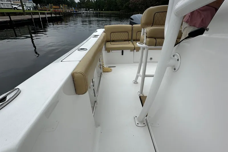 Slide: The Image of 2021 Sportsman Heritage 231 Center Console boat interior with tan seating and white deck. - 13