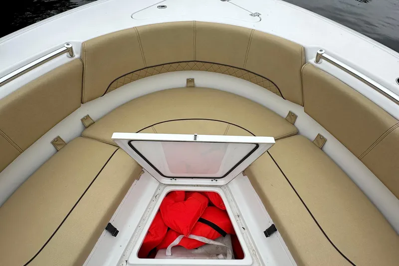 Slide: The Image of 2021 Sportsman Heritage 231 Center Console boat with open storage compartment and life jackets. - 5