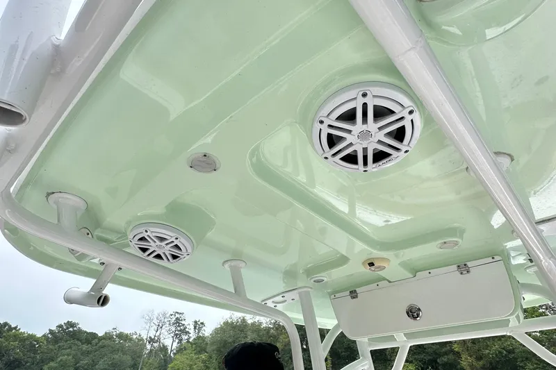 Slide: The Image of 2021 Sportsman Heritage 231 Center Console boat ceiling with speakers and storage compartment. - 6