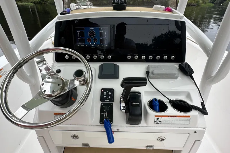 Slide: The Image of 2021 Sportsman Heritage 231 Center Console dashboard with steering wheel and controls. - 7