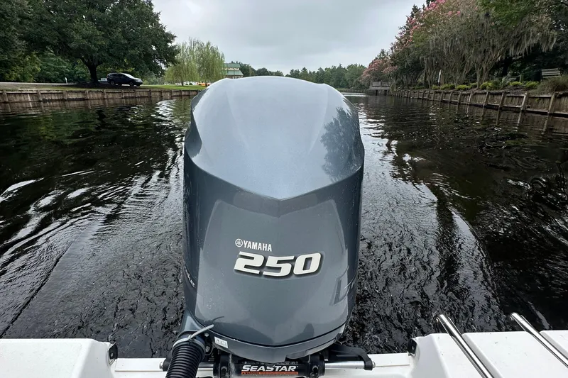 Slide: The Image of Yamaha 250 outboard motor on 2021 Sportsman Heritage 231 Center Console, cruising a scenic waterway. - 8