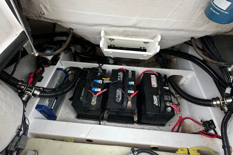 Slide: The Image of 2021 Sportsman Heritage 231 Center Console boat battery compartment with wiring and components. - 9