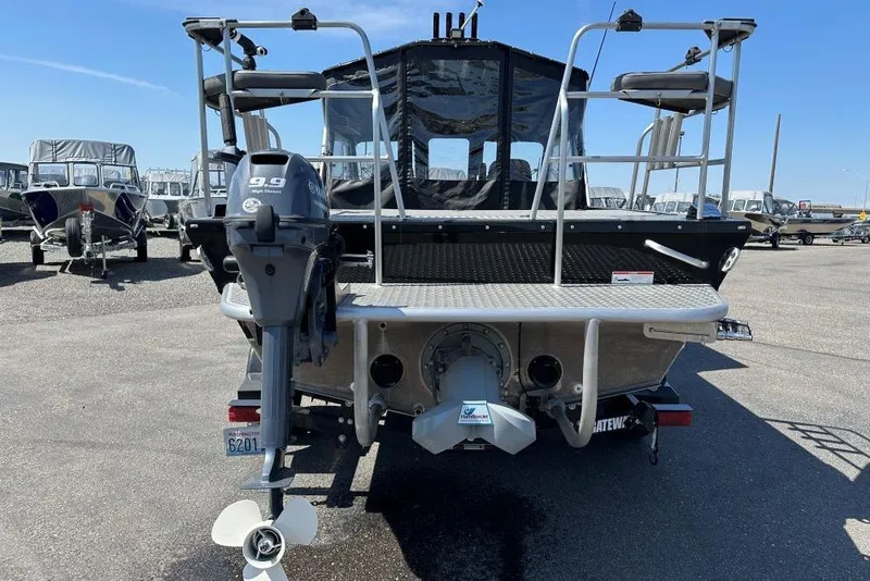 Slide: The Image of 2021 Thunder Jet Skeena Classic Jet boat rear view with outboard motor in a marina. - 3