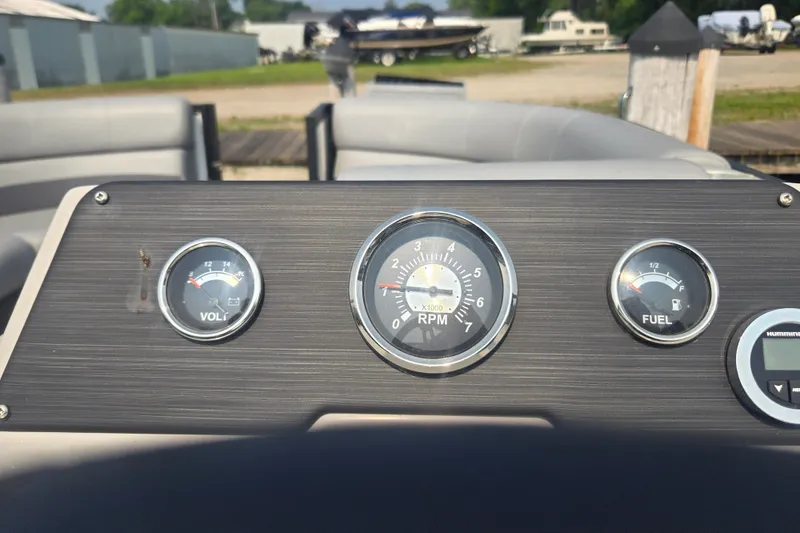 Slide: The Image of Dashboard of 2022 Flagship Pontoon E22CU with volt, RPM, and fuel gauges. - 12