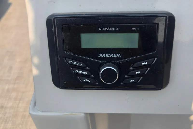 Slide: The Image of Kicker media center on 2022 Flagship Pontoon E22CU, featuring control buttons and display. - 13