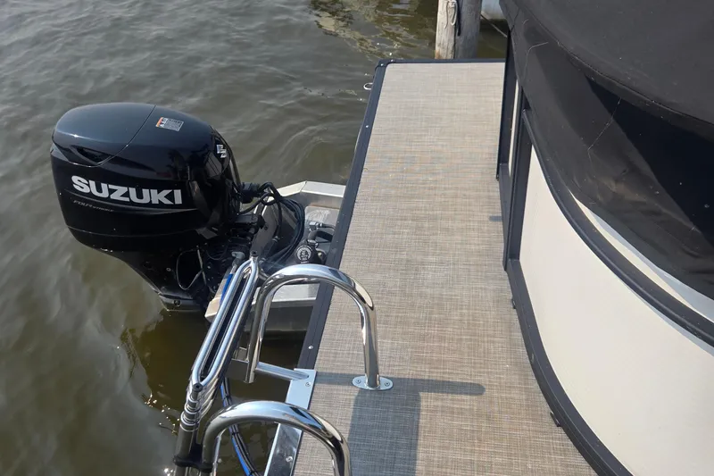 Slide: The Image of 2022 Flagship Pontoon E22CU with Suzuki outboard motor at dockside. - 15