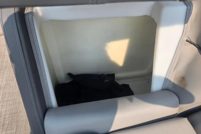 Slide: The Image of Open storage compartment in 2022 Flagship Pontoon E22CU boat seat. - 18