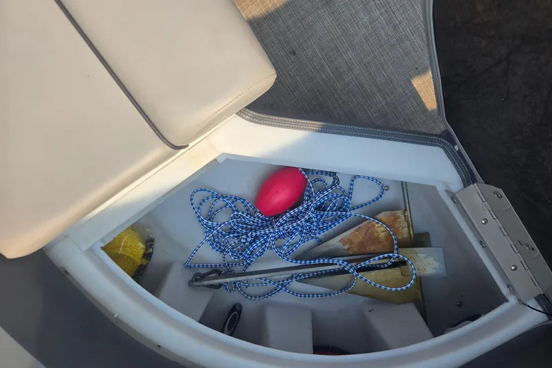 Slide: The Image of Storage compartment in 2022 Flagship Pontoon E22CU with ropes and accessories. - 19