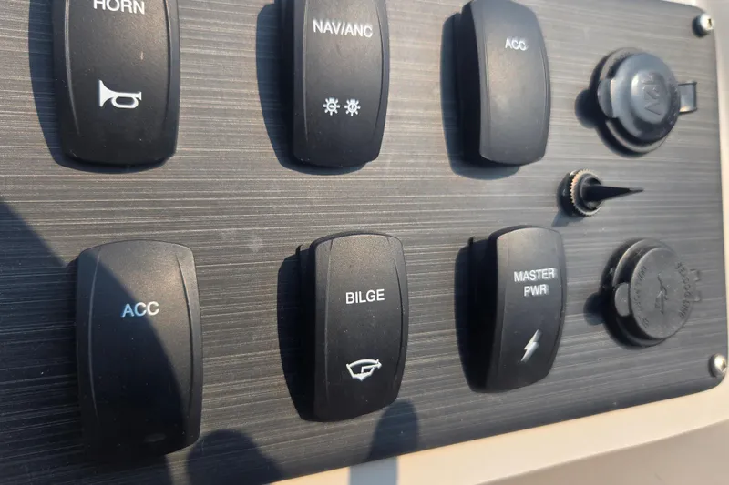 Slide: The Image of Control panel of 2022 Flagship Pontoon E22CU with labeled switches and power outlets. - 3