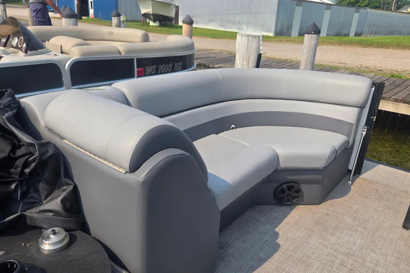 Slide: The Image of Luxurious seating on 2022 Flagship Pontoon E22CU, docked by the water. - 9