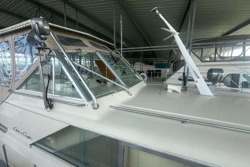 Slide: The Image of 1971 Chris-Craft Commander 42 boat under a metal roof, showcasing its classic design. - 12