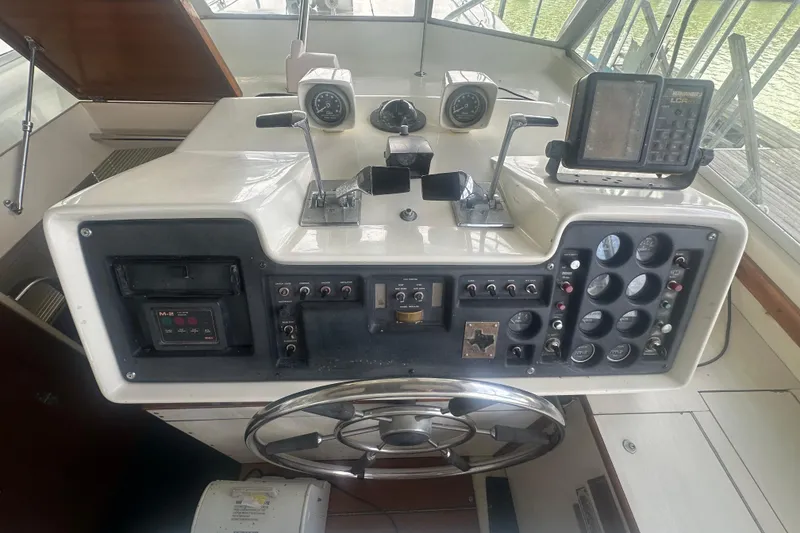 Slide: The Image of 1971 Chris-Craft Commander 42 boat dashboard with steering wheel and control panel. - 18