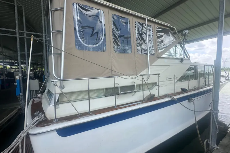 Slide: The Image of 1971 Chris-Craft Commander 42 docked under a covered marina, featuring classic design elements. - 2
