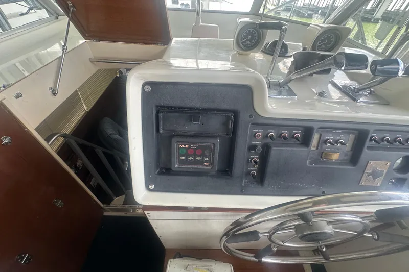 Slide: The Image of 1971 Chris-Craft Commander 42 helm with gauges, controls, and steering wheel. - 20