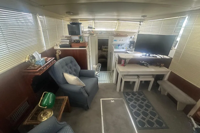 Slide: The Image of Interior of a 1971 Chris-Craft Commander 42 with cozy seating and modern amenities. - 26