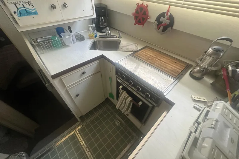 Slide: The Image of 1971 Chris-Craft Commander 42 kitchen with stove, sink, and nautical decor. - 27