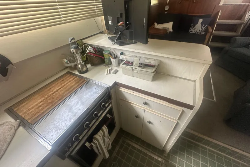 Slide: The Image of 1971 Chris-Craft Commander 42 kitchen with stove, cabinets, and countertop accessories. - 29