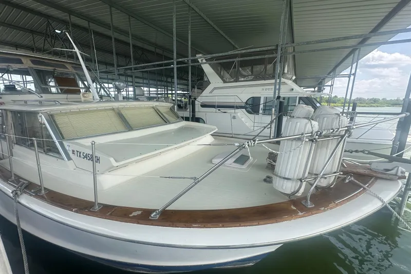Slide: The Image of 1971 Chris-Craft Commander 42 docked under a covered marina, showcasing classic design. - 3