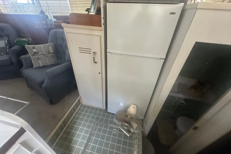 Slide: The Image of Interior of 1971 Chris-Craft Commander 42 with fridge, seating, and bathroom. - 30