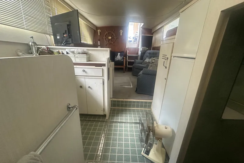 Slide: The Image of Interior of a 1971 Chris-Craft Commander 42 boat, featuring a cozy living area. - 37