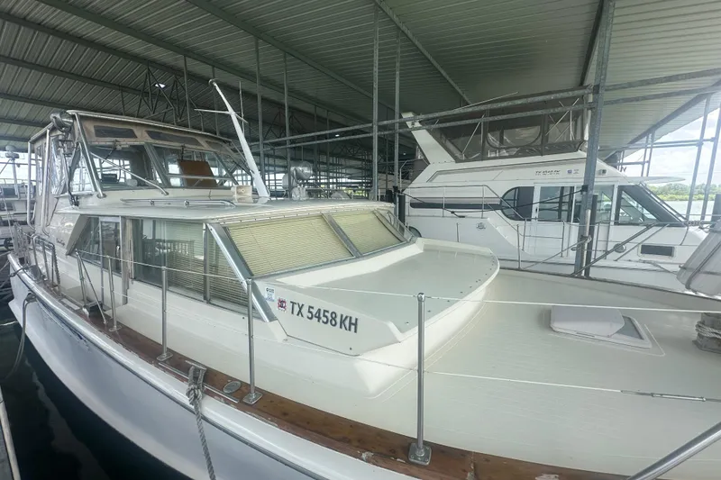 Slide: The Image of 1971 Chris-Craft Commander 42 boat docked in a covered marina, side view. - 4