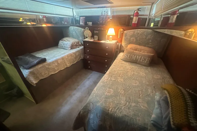 Slide: The Image of Cozy cabin interior of 1971 Chris-Craft Commander 42 with twin beds and warm lighting. - 41