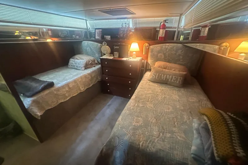 Slide: The Image of Cozy cabin interior of 1971 Chris-Craft Commander 42 with twin beds and warm lighting. - 42