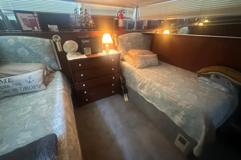 Slide: The Image of 1971 Chris-Craft Commander 42 cabin with twin beds, cozy decor, and ambient lighting. - 51
