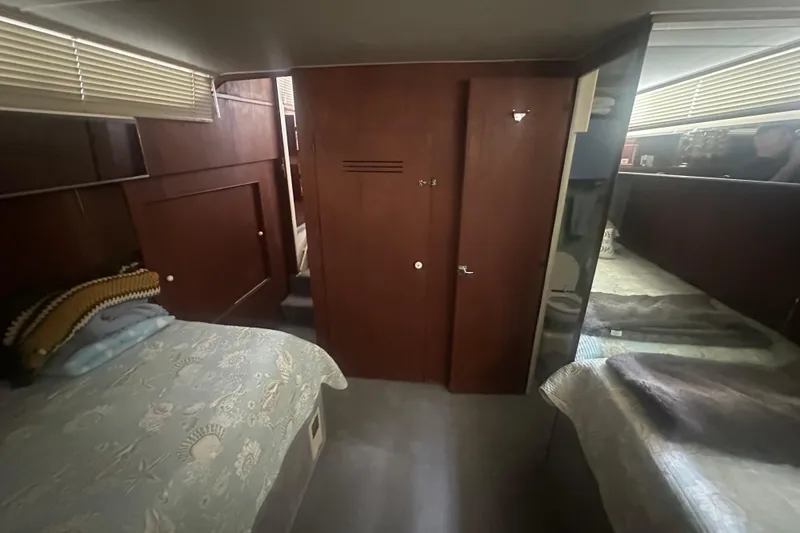 Slide: The Image of 1971 Chris-Craft Commander 42 interior cabin with twin beds and wooden paneling. - 52