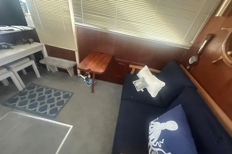 Slide: The Image of 1971 Chris-Craft Commander 42 interior with navy sofa, nautical decor, and wooden accents. - 55