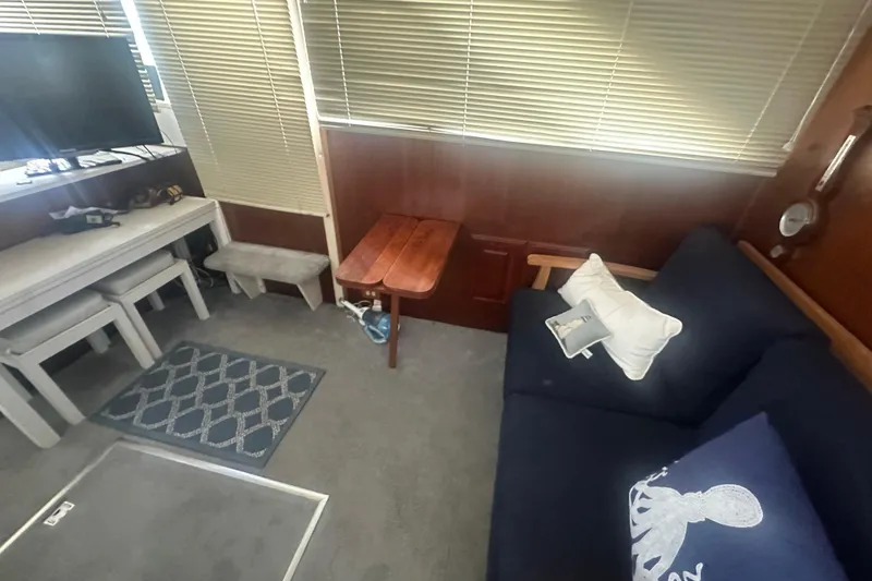 Slide: The Image of 1971 Chris-Craft Commander 42 interior with sofa, table, TV, and nautical decor. - 56