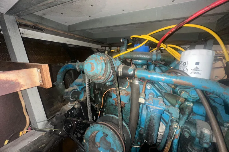 Slide: The Image of Engine compartment of a 1971 Chris-Craft Commander 42 with visible wiring and components. - 60