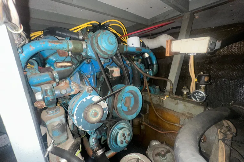 Slide: The Image of Engine compartment of a 1971 Chris-Craft Commander 42, showcasing mechanical components and wiring. - 62