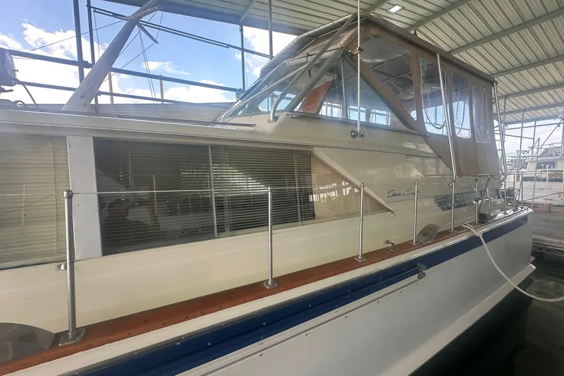 Slide: The Image of 1971 Chris-Craft Commander 42 yacht docked under a covered marina. - 7