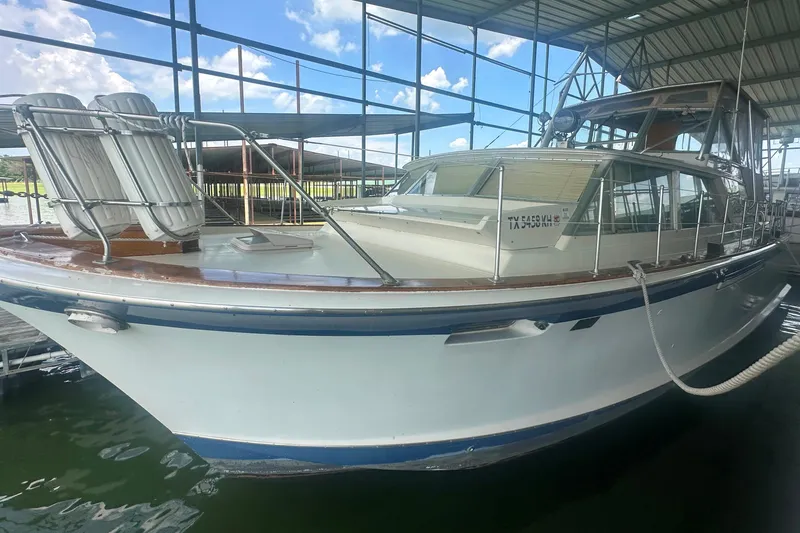 Slide: The Image of 1971 Chris-Craft Commander 42 docked in a marina under a metal canopy. - 8