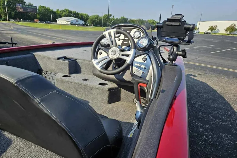 Slide: The Image of 2023 Bass Tracker 195 XTE boat interior with steering wheel and dashboard controls. - 5