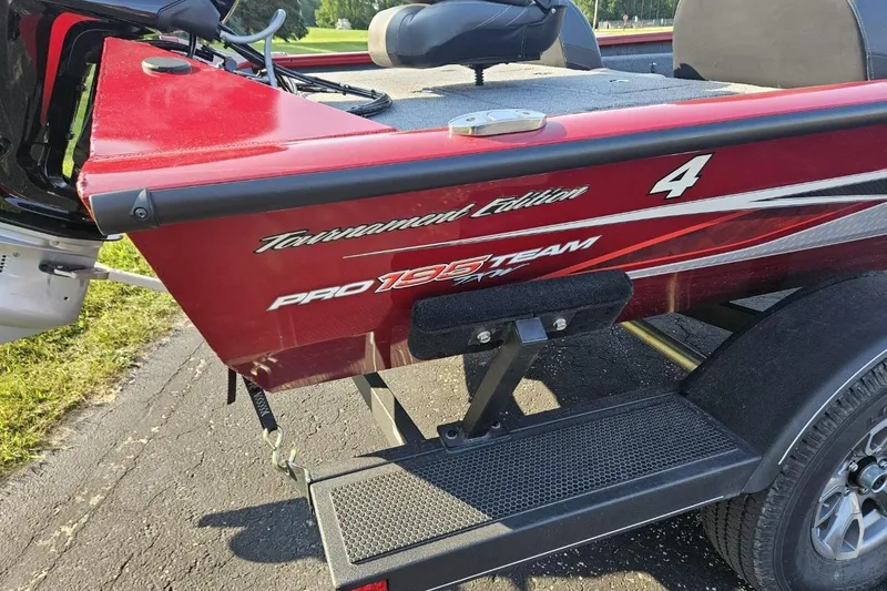 Slide: The Image of 2023 Bass Tracker 195 XTE Tournament Edition boat, red with decals, on a trailer. - 6