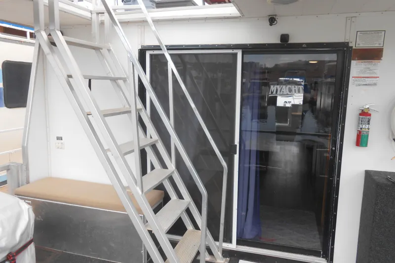Slide: The Image of 2004 Myacht 4815 houseboat interior with stairs and sliding glass door. - 11