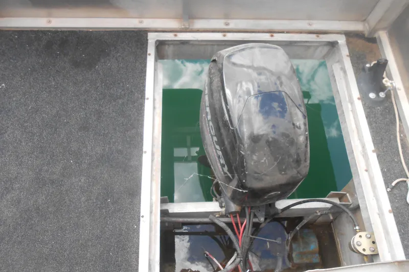 Slide: The Image of 2004 Myacht 4815 boat engine compartment with Mercury outboard motor. - 13