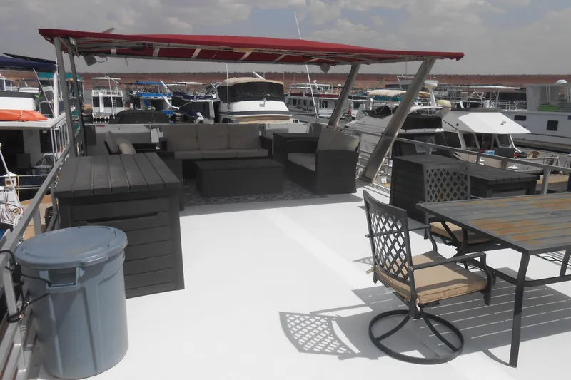 Slide: The Image of Upper deck of 2004 Myacht 4815 with seating and dining area under red canopy. - 16