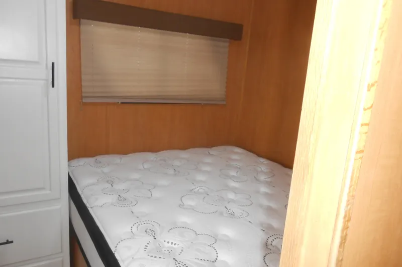 Slide: The Image of 2004 Myacht 4815 interior with cozy bed and wooden paneling. - 9