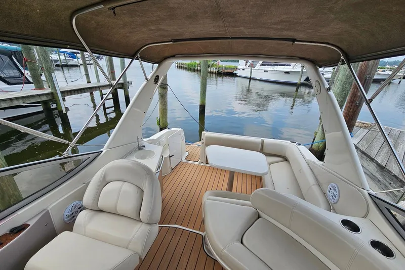 Slide: The Image of 1999 Regal Commodore 292 boat interior with seating and table, docked at marina. - 12