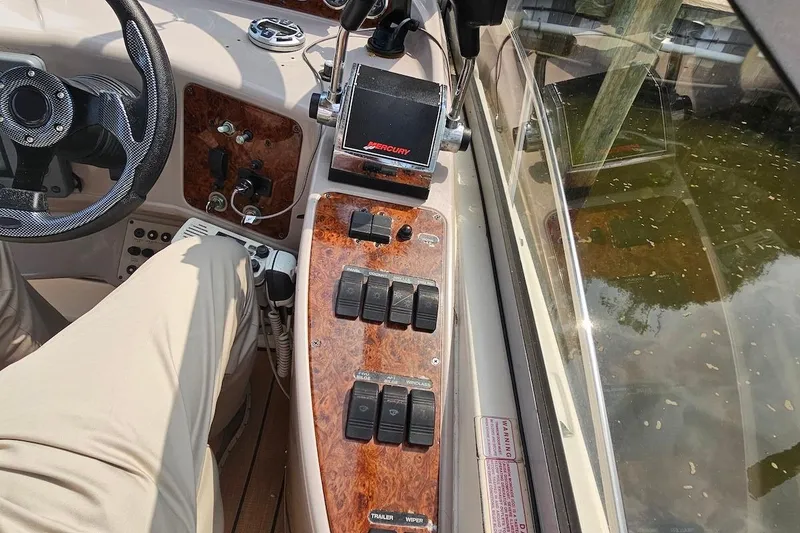Slide: The Image of 1999 Regal Commodore 292 boat dashboard with controls and steering wheel. - 14