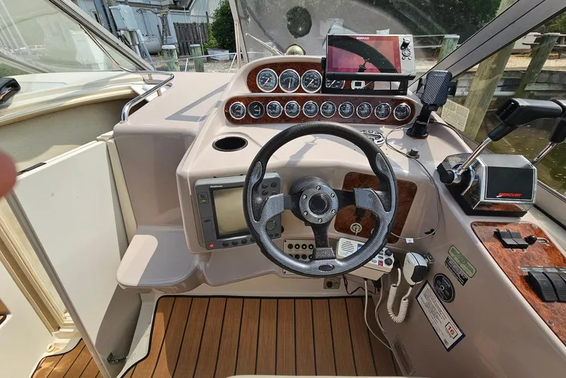 Slide: The Image of 1999 Regal Commodore 292 boat cockpit with steering wheel, gauges, and navigation equipment. - 15