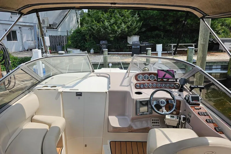 Slide: The Image of 1999 Regal Commodore 292 boat interior with steering wheel and control panel at dock. - 16