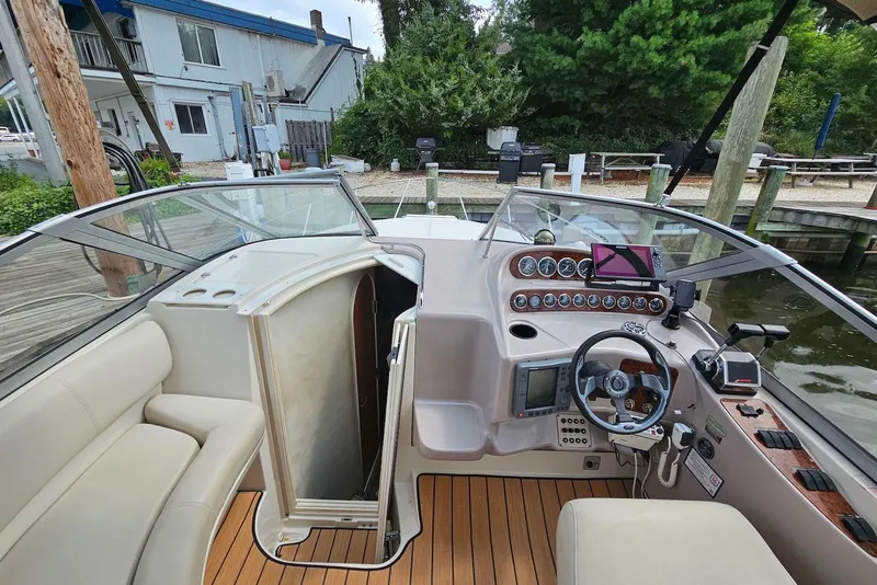Slide: The Image of Interior view of 1999 Regal Commodore 292 boat with helm and seating area. - 17